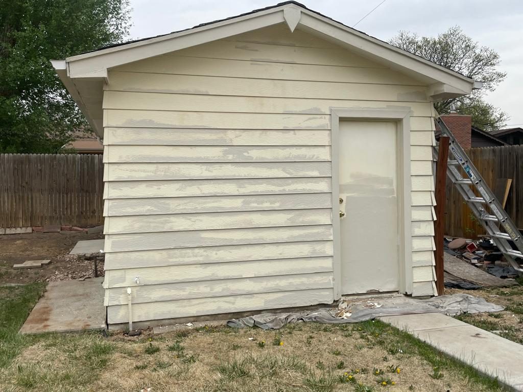 Before: Denver metro · Backyard shed repaint · White with black fascia