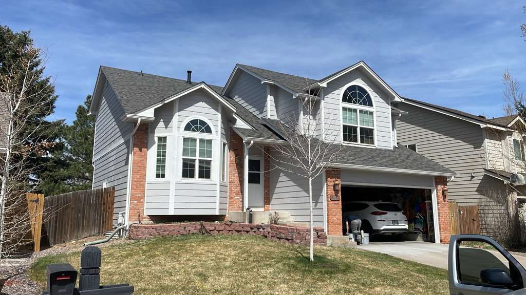 Freshly painted two-story home in gray with white trim